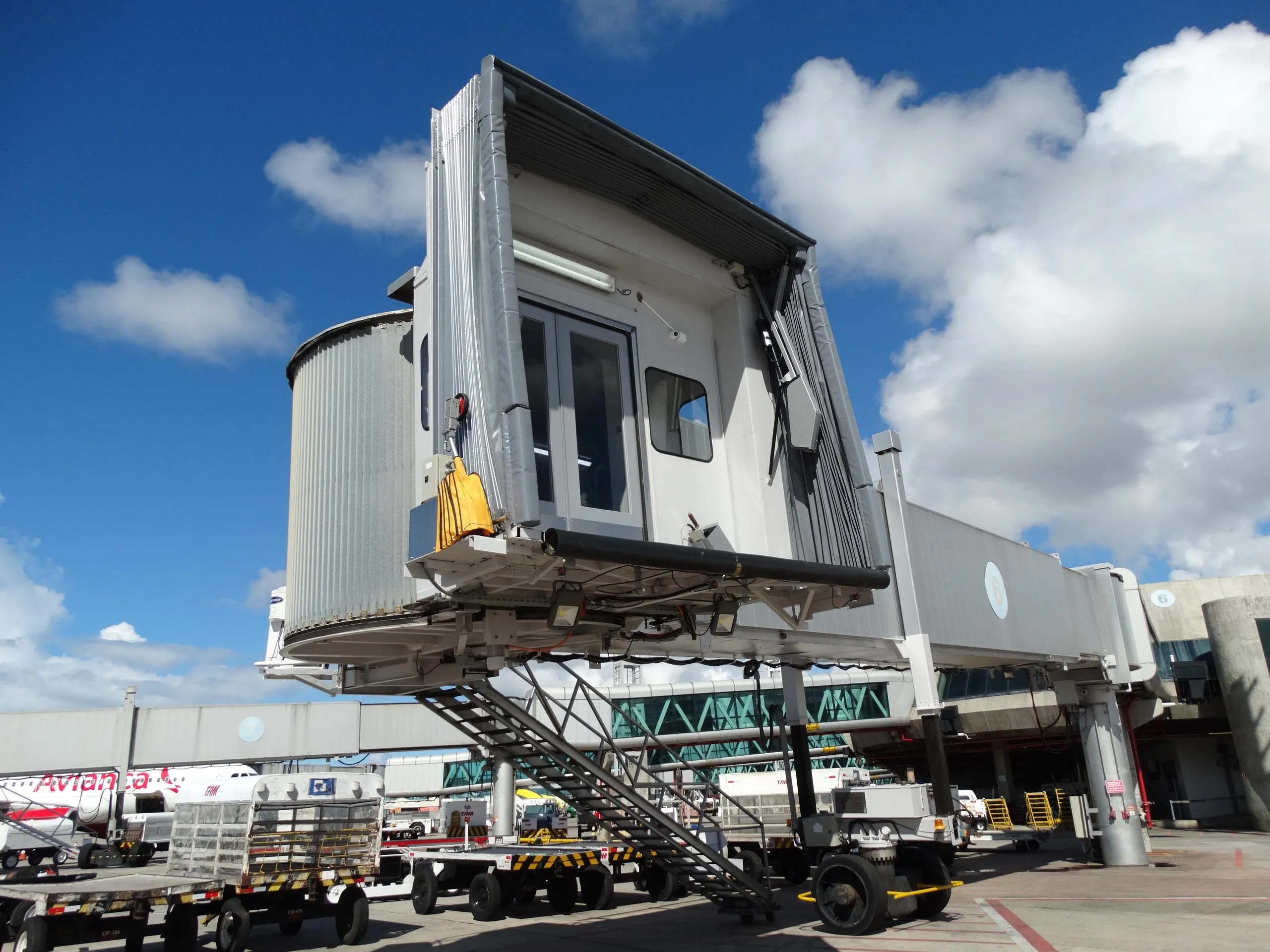 Cranes installing a passenger boarding bridge at an airport in Brazil