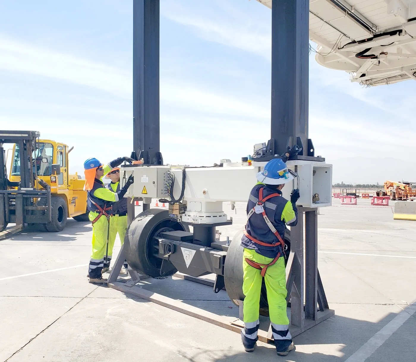 APS LATAM team fitting the wheel assembly of a boarding bridge on the apron