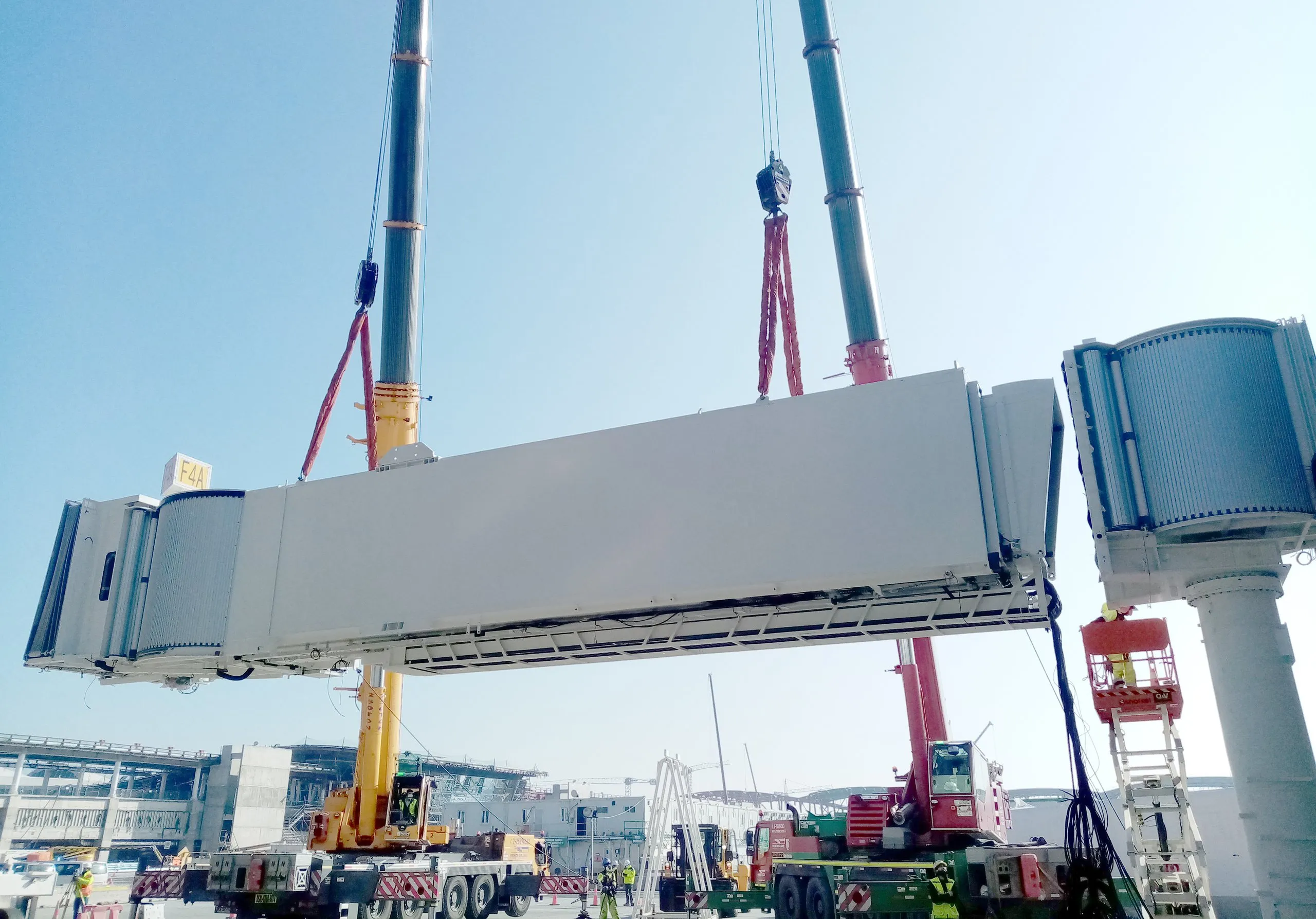 Crane lifting large airport equipment