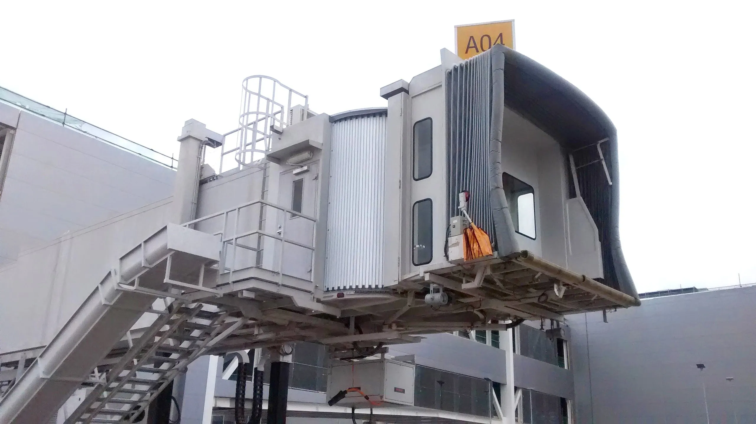 Boarding bridge docked to an aircraft on the apron