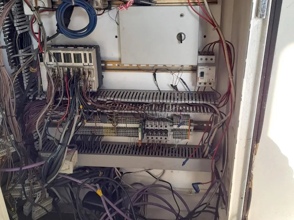 Electrical panel with deteriorated wiring before the work