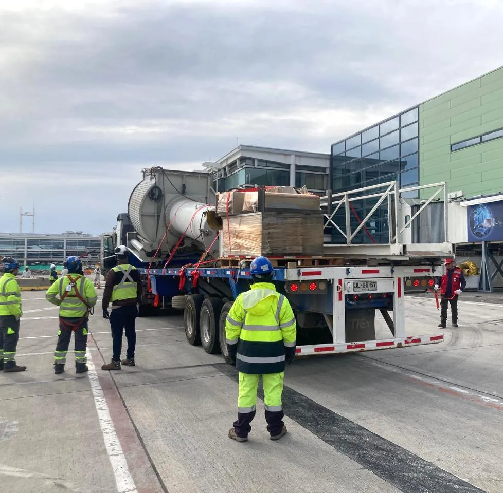 APS LATAM crew escorting a boarding bridge being moved by truck